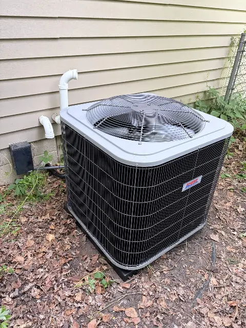 Air conditioning unit with piping next to a house in Maple Grove