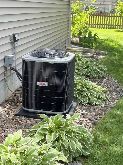 Air conditioning unit surrounded by landscaping in Maple Grove, MN